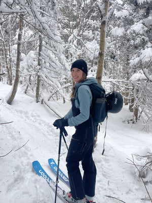 Woman backcountry skiing in the snowy mountains