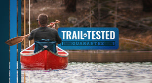 Trail Tested Guarantee - Man paddling in a canoe sitting in the Canoe IV paddle chair