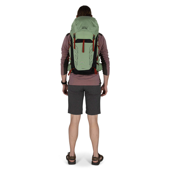 Backpacking man carrying the Osprey and Crazy Creek Collab backpack full body on white - facing back
