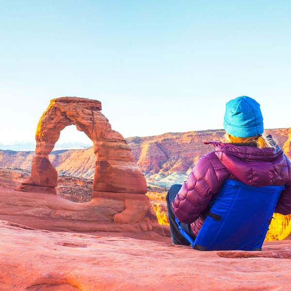 Woman sitting in front of Zion rocks in Utah while sitting in her blue crazy creek chair