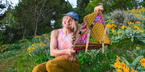 Rachel holding up her Pine creek Hex 2.0 flower printed chair