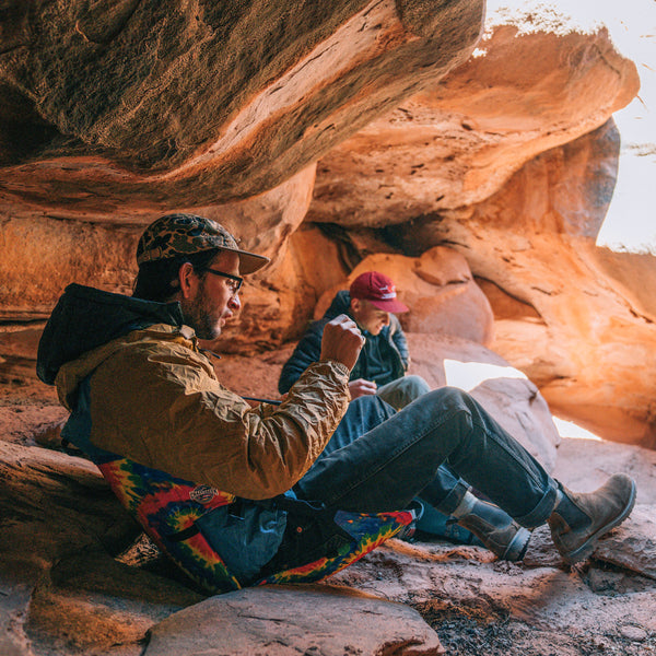 two men relaxing in a red cave in their chairs