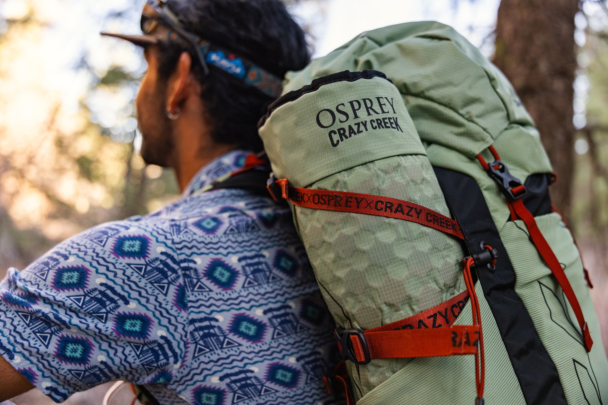 Closeup of the Crazy Creek and Osprey Collab chair rolled up and stowed in the side of the backpack