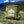 Green chair with 'Public Lands' logo screen printed on it in a mountainous landscape